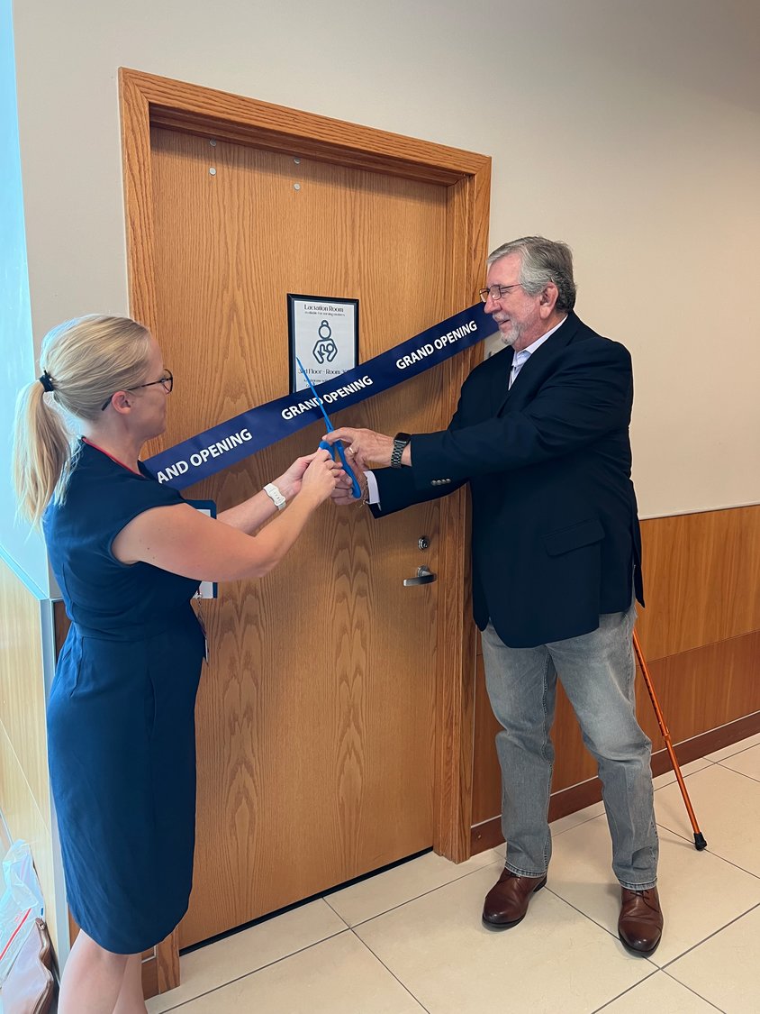 OKEECHOBEE -- Abby Spears, president of the Martin County Women Lawyers Association (left) and Okeechobee County Clerk of Court Jerry Bryant (right) officiated at the dedication of the new lactation room in the Okeechobee County Judicial Center on July 7. [Photo by Katrina Elsken/Lake Okeechobee News]
